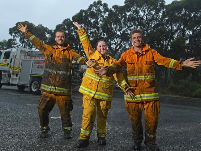 25/01/21 - CFS volunteers Nick Svetec from Barmera, Hayllee Camplbell from Morgan CFS, Joel Trace from Barmera CFS celebrate the rain providing relief to the Cherry Gardens fire.Pictured outside the Bradbury Country Fire Service station.Picture: Tom Huntley