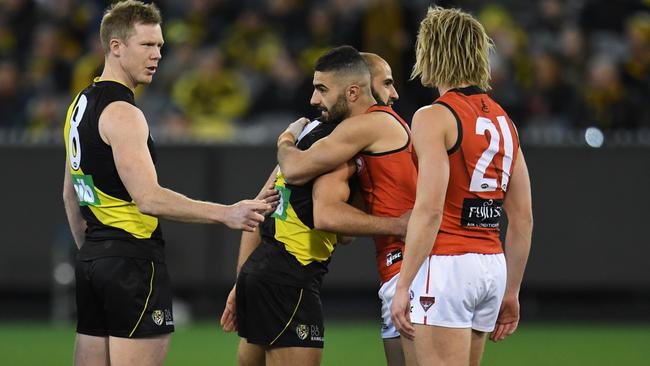 Richmond star Bachar Houli and Essendon’s Adam Saad embrace during the coin toss on Friday. Photo: AAP