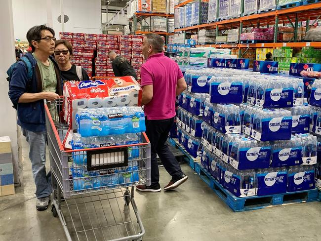 People buy water, food and toilet paper at a store, as they begin to stockpile essentials from fear that supplies will be affected by the spread of the COVID-19, coronavirus, outbreak across the country, in Los Angeles. Picture: AFP