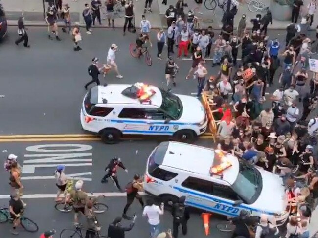 An NYPD SUV (in the foreground) drives into protesters in Brooklyn.