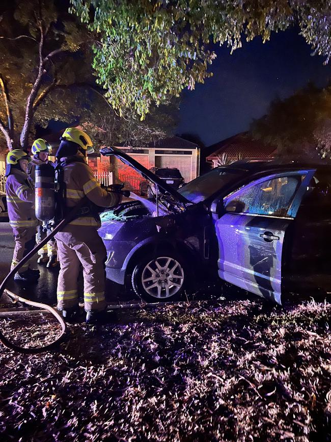 Firefighters attend to the car shortly after the attack.