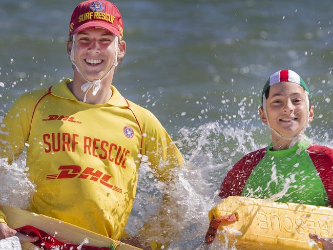 Summer campaign to stop drownings. Patrol members from Life Saving Victoria and Nippers on the beach at South Melbourne Life Saving Club. Patrol member 17 and Nipper Luc Basile 12 ready to tackle the surf and save lives.  Picture: David Caird