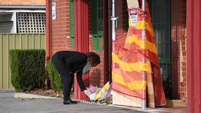 A woman leaves flowers at the scene where Sophia was killed. Picture: Tricia Watkinson