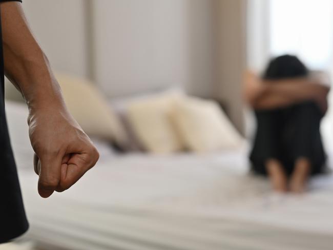 istock generic:  woman, abuse, DV, domestic violence, harassment, sexual harassment.   Selective focus on the fist male with crying man sits on a bed as the background, Violence, Love and relationships, Gay couple, sexual harassment concept. . Picture: istock