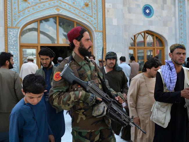 An armed Taliban fighter stands guard as devotees leave after prayers at the Pul-e Khishti Mosque in Kabul. Picture: AFP