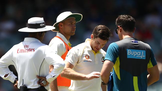 Tim Paine receives some attention on his finger. Picture: Getty