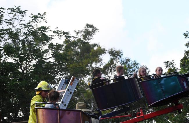 People are seen being rescued by police from the octopus ride at Freds Pass Show. PICTURE: KERI MEGELUS