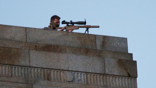 A sniper is seen on the roof as part of the security on the day. Picture: AAP Image/David Crosling