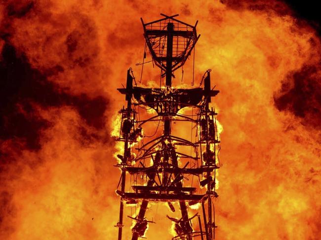 FILE - In this Aug. 31, 2013, file photo, the "Man" burns on the Black Rock Desert at Burning Man near Gerlach, Nev. A Nevada sheriff says a man who ran into the flames at the Burning Man festival's signature burning ceremony has died. Pershing County Sheriff Jerry Allen identified the man as Aaron Joel Mitchell, 41, who died Sunday, Sept. 3, 2017, morning at the UC Davis hospital burn center in California. (Andy Barron/Reno Gazette-Journal via AP, File)