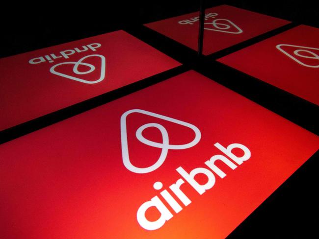 FILES) In this file illustration photo taken on November 22, 2019 shows the logo of the online lodging service Airbnb displayed on a tablet in Paris. - Airbnb is seeking to raise some $2.6 billion in its upcoming share offering, which could give the home-sharing giant a valuation as high as $35 billion, an updated regulatory filing showed on December 1, 2020. The California group said its initial public offering would include some 51.9 million shares in a range of $44 to $50. (Photo by Lionel BONAVENTURE / AFP)