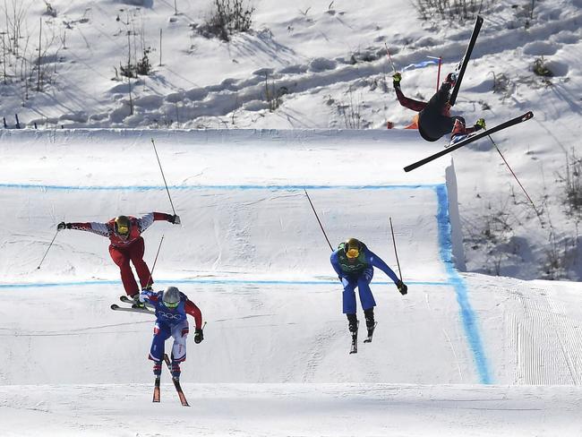 Christopher Del Bosco of Canada, right, flies through the air before crashing as Sergey Ridzik, Olympic Athletes of Russia, left to right, Francois Place of France and Siegmar Klotz of Italy compete in the men's ski cross elimination round at Phoenix Snow Park at the 2018 Winter Olympics in Pyeongchang, South Korea, Wednesday, Feb. 21, 2018. (Jonathan Hayward/The Canadian Press via AP)