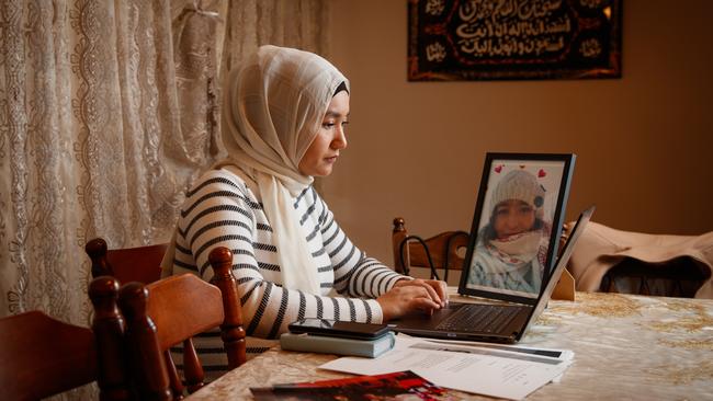 Uyghur Marhaba Salay with a picture of her missing sister, Mahira Yakub on July 2, 2020 in Adelaide, South Australia. Picture Matt Turner.