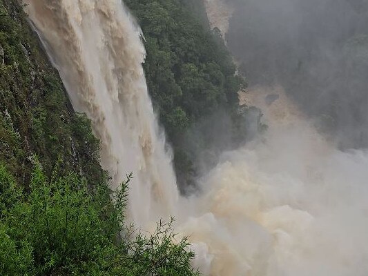 Incredible waterfall overflow as rainbomb descends on NSW