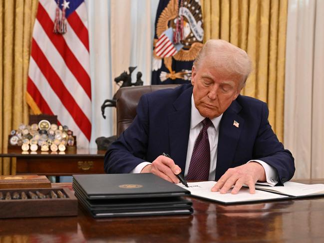 US President Donald Trump signs an executive order to declassify files of former President John F. Kennedy, former Attorney General Robert F. Kennedy and civil rights leader Martin Luther King Jr., in the Oval Office of the White House in Washington, DC, on January 23, 2025. (Photo by ROBERTO SCHMIDT / AFP)