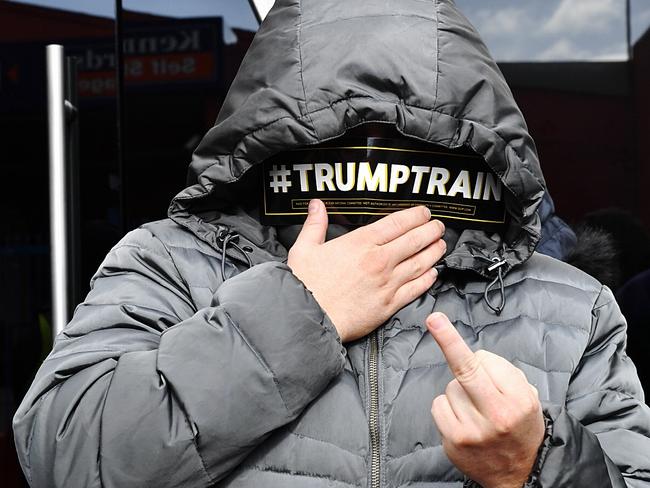 A Trump supporter flips cameras off while waiting to see Milo Yiannopoulos. Picture: Jake Nowakowski