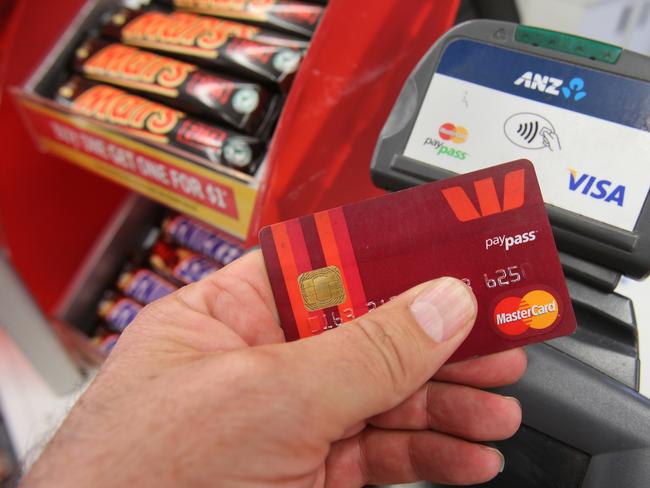 Stock image of a customer using a tap-and-go credit card in a store, Wednesday, Nov. 27, 2013. The Victorian police commissioner Lucinda Nolan says there has been a significant rise in credit card crime which has been attributed to the tap-and-go cards. (AAP Image/David Crosling) NO ARCHIVING