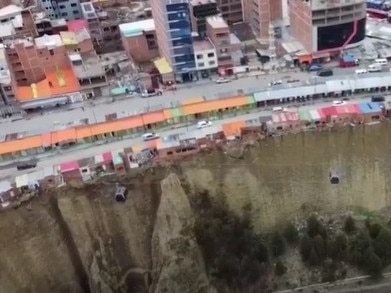 Hanging off the edge of a 60 metre cliff lies a row of flimsy houses that appear to be mere inches away from plunging onto the razor rocks below.