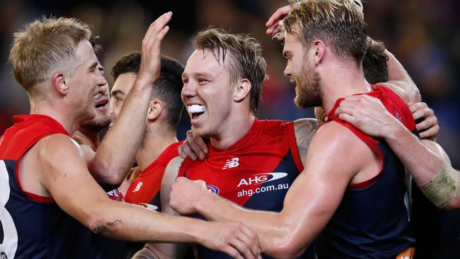 James Harmes is swamped by teammates Bernie Vince, left, and Jack Watts during their hard-fought Round 12 victory against Collingwood. Picture: GETTY IMAGES