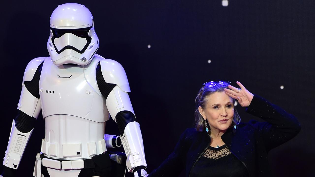 US actor Carrie Fisher poses with a storm trooper at the opening of the European Premiere of "Star Wars: The Force Awakens" in London. Picture: AFP