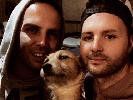 Milo, the five-year-old jack russell with his owner, Jason Whatnall and his partner Nick. Photo: supplied.