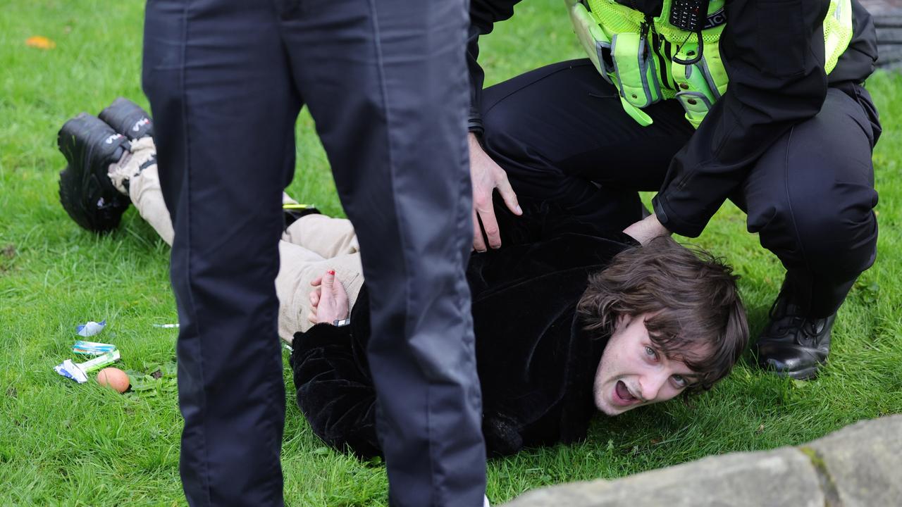 Police arrest the protester after throwing eggs. Picture: Chris Jackson/Getty Images