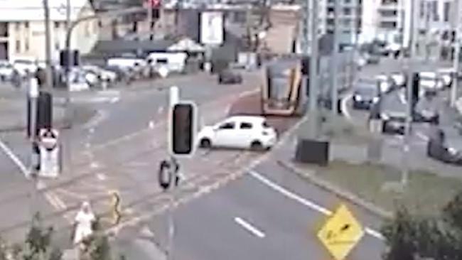 A car crosses into the path of a moving tram. Picture: GoldlinQ