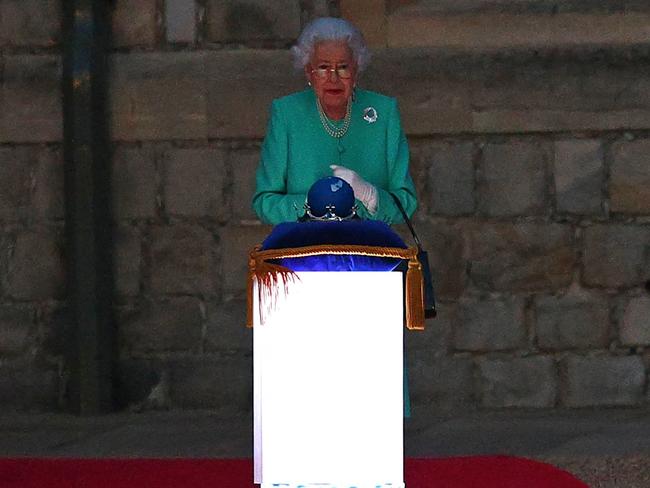 Britain's Queen Elizabeth II lights the principle beacon. Picture: AFP.