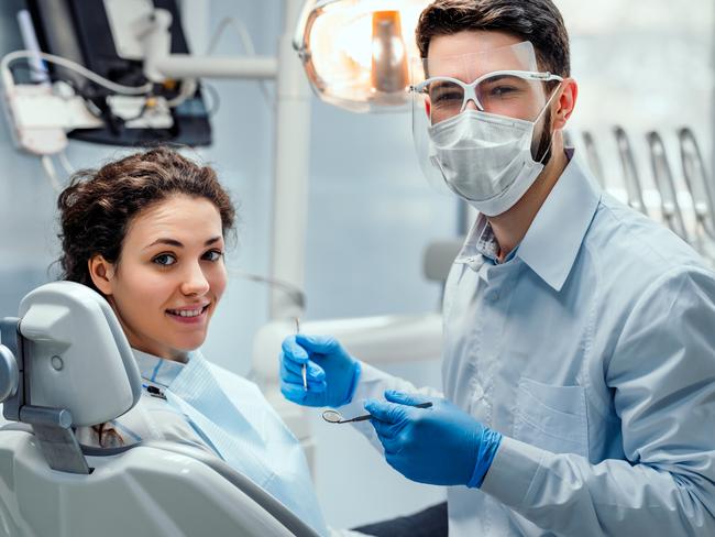 Beautiful woman patient having dental treatment at dentist's office. Woman visiting her dentist. Picture: iStock.