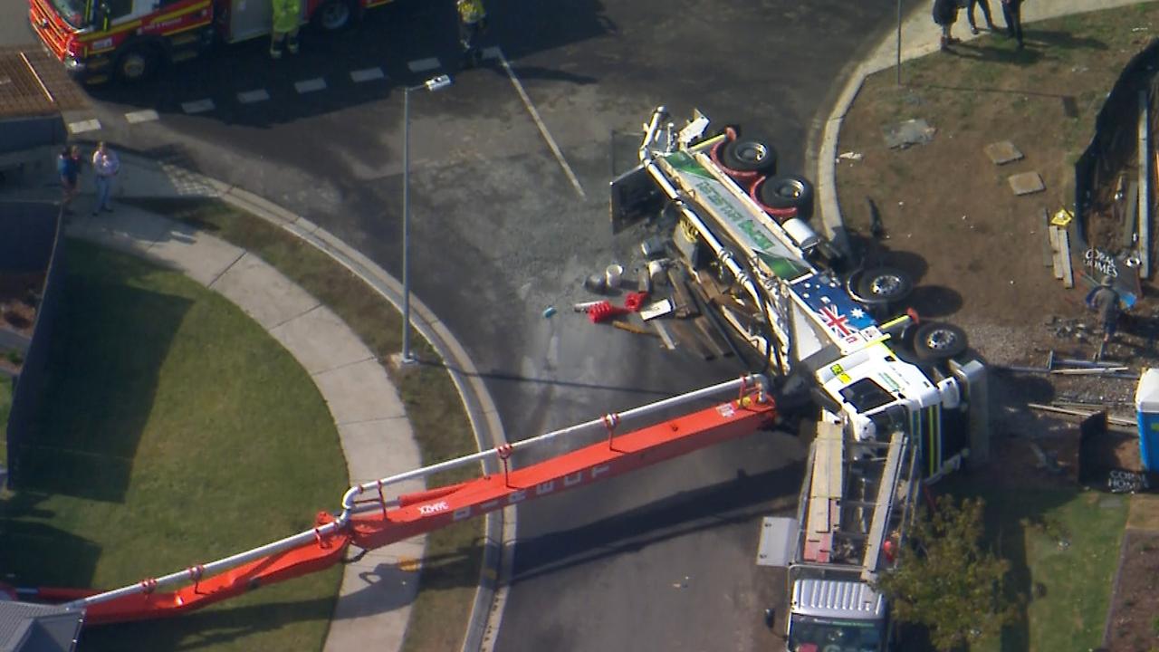 A concrete pumping truck has toppled into home at Deebing Heights, the concrete pour was happening for a property across the road. Picture: 7News