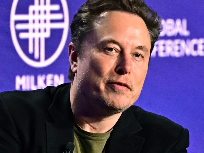 (FILES) Tesla CEO Elon Musk speaks at the 27th annual Milken Institute Global Conference at the Beverly Hilton in Los Angeles on May 6, 2024. Tesla and SpaceX tycoon Elon Musk lashed out June 10, 2024 at a partnership between OpenAI and Apple, saying the threat to data security will make him ban iPhones at his companies. (Photo by Frederic J. BROWN / AFP)