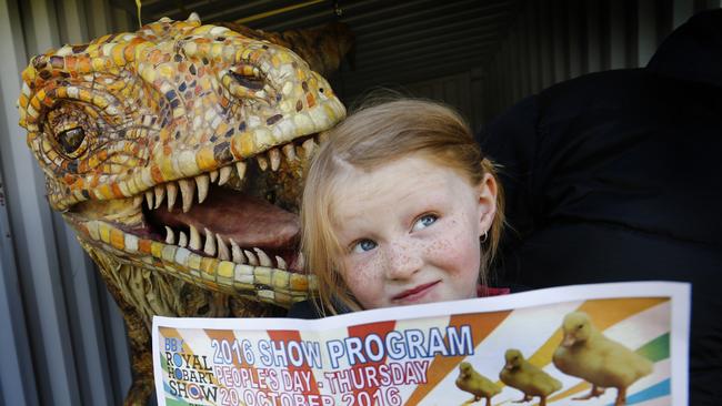 Pony rider Matilda Cameron, 6, of Launceston – who rode to victory in the leading rein event yesterday – has a close encounter with “Australovenator”, one of the lifelike dinosaurs on display at the show. Pictures: KIM EISZELE