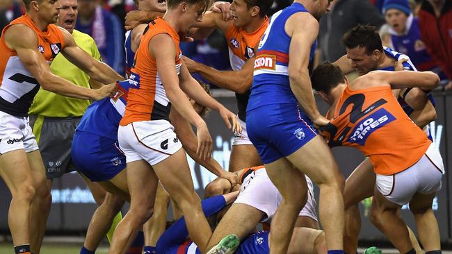 Toby Greene feels the wrath of Bulldogs players. Picture: Getty Images