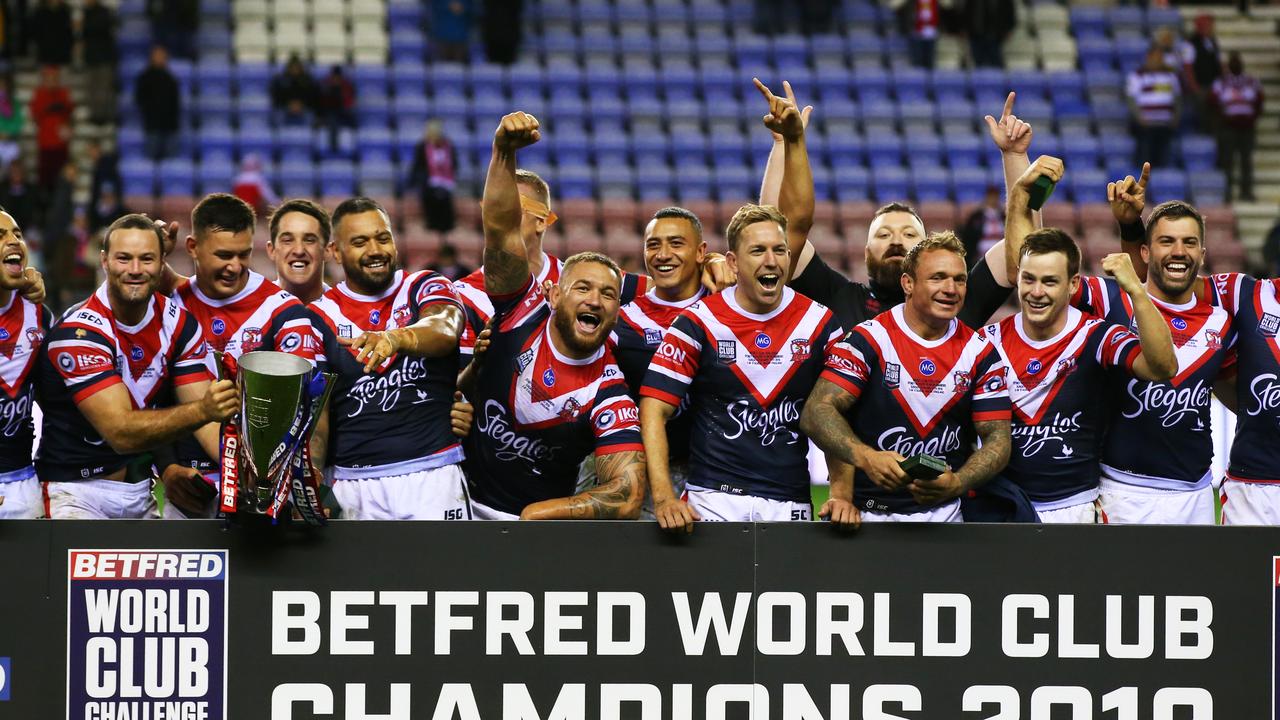 Sydney Roosters players celebrate victory with the trophy after the World Club Challenge match with Wigan