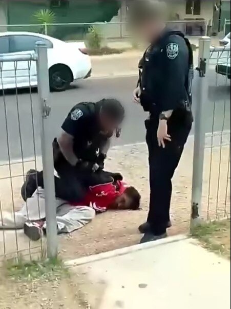 The officer then restrains the man by placing a knee on his hip, before handcuffing him. Picture: Facebook