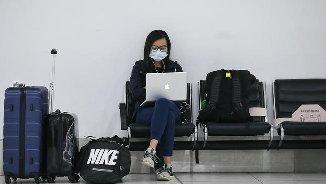 A woman works at Melbourne Airport on Tuesday. Picture: Ian Currie