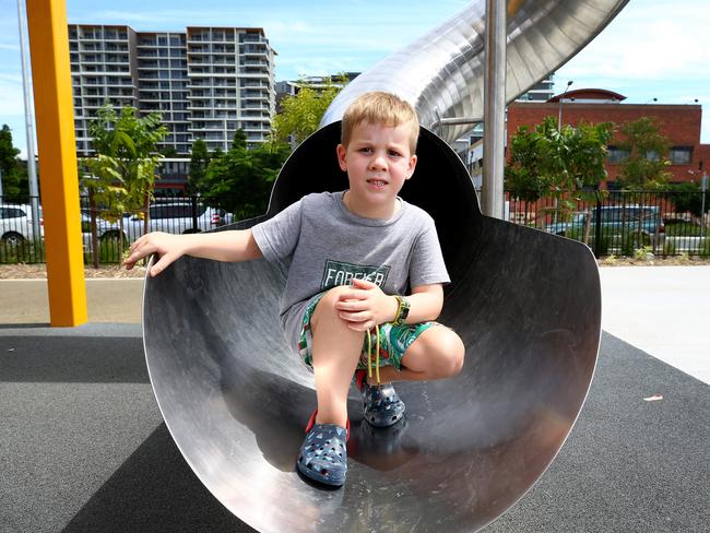 Archie Stephenson on one of the metal slides at Hercules Street Park in Hamilton. Photo: Adam Head