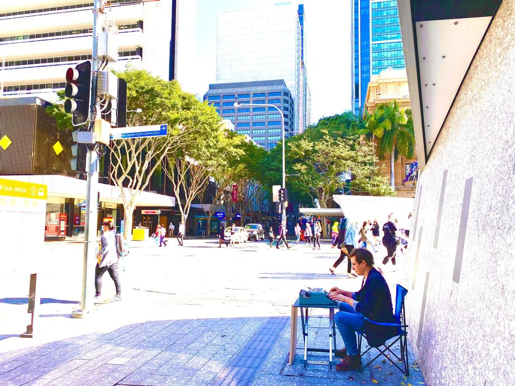 You never know where the next story will come from ... Trent Dalton in a quiet moment during his street-corner mission. Picture: Fiona Franzmann