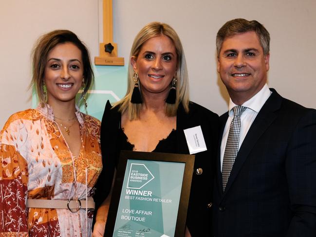 Emily Belperio and Renee Demana from Love Affair Boutique accept an award from Mayor Robert Bria at the Eastside Small Business Awards held at St Peter's Hall in Adelaide, Wednesday, March 28, 2018. (AAP Image/ Morgan Sette)