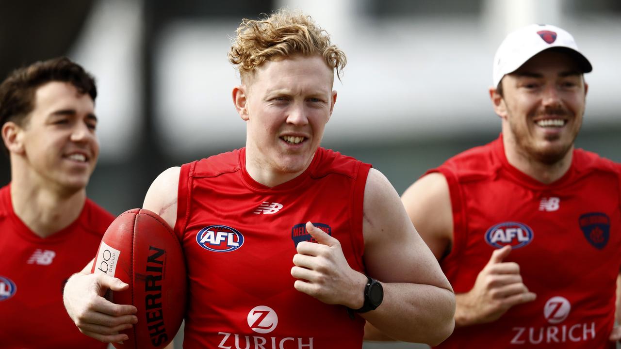 Clayton Oliver and teammates run laps at Gosch's Paddock as the Demons prepare for their huge match with Geelong this weekend.