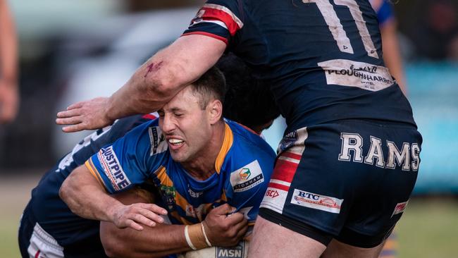 Kangaroos captain Michael Stevens ducks under a tackle from Rams Brad Hopkins. News Local, Pictures by Julian Andrews.