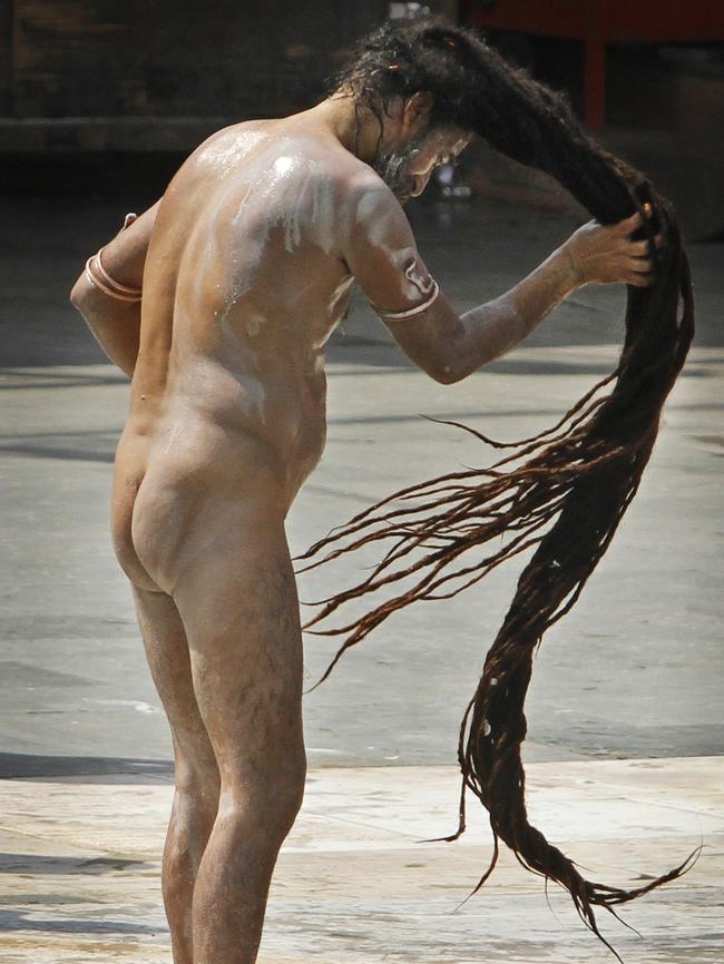 A Hindu holy man wrings the water from his hair after bathing in the Ganges. Picture: AP