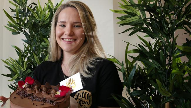 Whitney Koitka shows off one of the raw vegan cakes available in-store at Little Raw Co. in Cremorne. Picture: Virginia Young