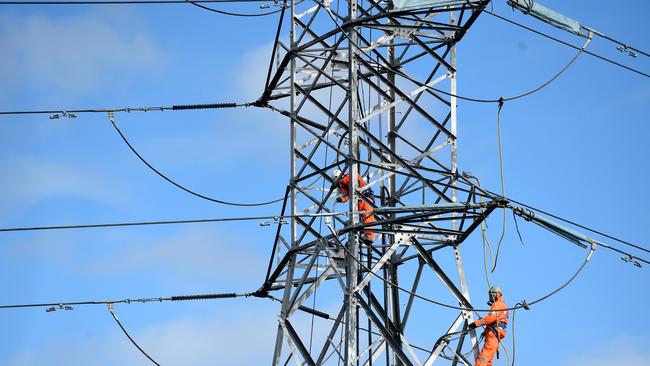 **FILE** A July 20, 2015 file photo of workers seen on a high tension electricity pylon in suburban Sydney. The energy market operator warns NSW and South Australia could face power shortages as temperatures soar in coming days, Friday, Feb. 10, 2017. (AAP Image/Mick Tsikas) NO ARCHIVING