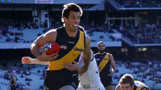 Alex Rance surges clear of a tackle against Fremantle in Round 17, 2013.