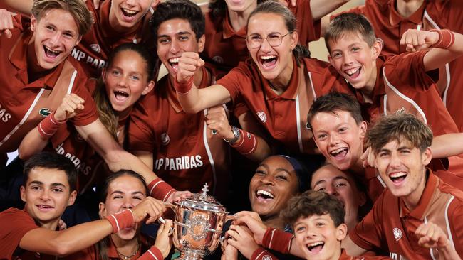 Gauff with the Coupe Suzanne Lenglen trophy as she celebrates with ball kids. Picture: Getty Images