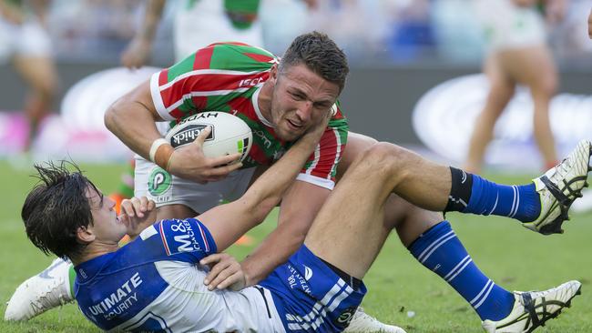 Lachlan Lewis of the Bulldogs tackles Sam Burgess of the Rabbitohs during the Round 6 NRL match between the South Sydney Rabbitohs and the Canterbury Bulldogs at ANZ Stadium in Sydney, Friday, April 19, 2019. (AAP Image/Craig Golding) NO ARCHIVING, EDITORIAL USE ONLY