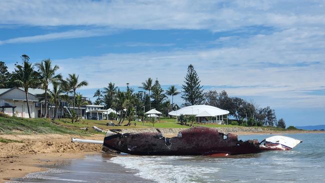 The burnt yacht on November 25, 2022, with the Emu Park Surf Lifesaving Club in the background. Photo Darryn Nufer.