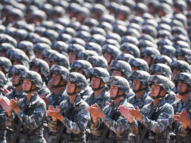 Chinese soldiers applaud during a military parade at the Zhurihe training base in China's northern Inner Mongolia region on July 30, 2017. Picture: AFP PHOTO / STR / China OUT