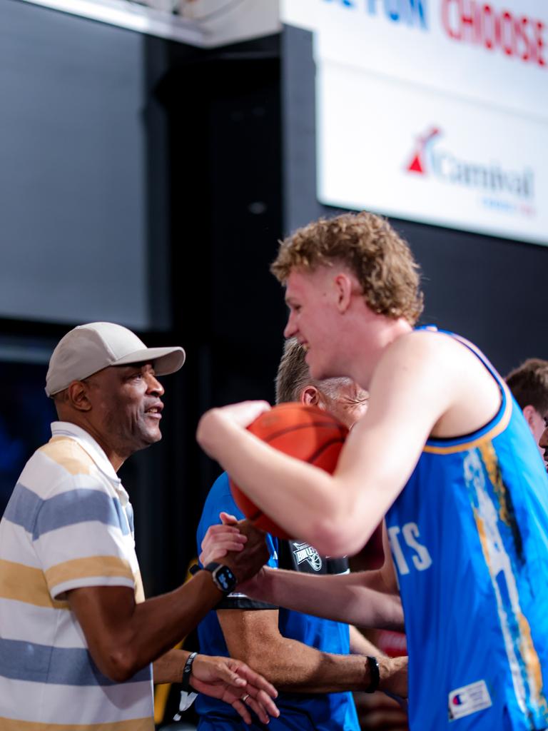 Legendary Bullet Leroy Loggins congratulates Brisbane's youngest player, 17-year-old Next Star Rocco Zikarsky, after a victory.