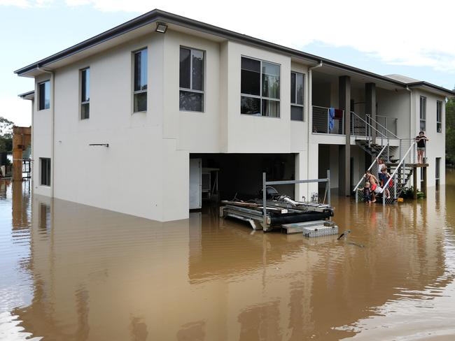 Wet weather - Flooding in Logan / Beenleigh / Waterford.Mother of three Kylie Fulop and partner Ian Foster at their Beenleigh home in Omaru Street which was inundated by the Logan River.Picture: NIGEL HALLETT